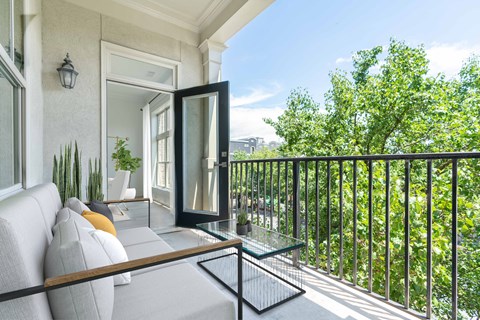 a living room with a couch and a balcony