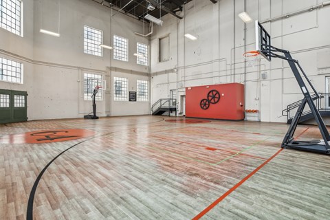 a basketball court in an empty gym with a red box in the middle