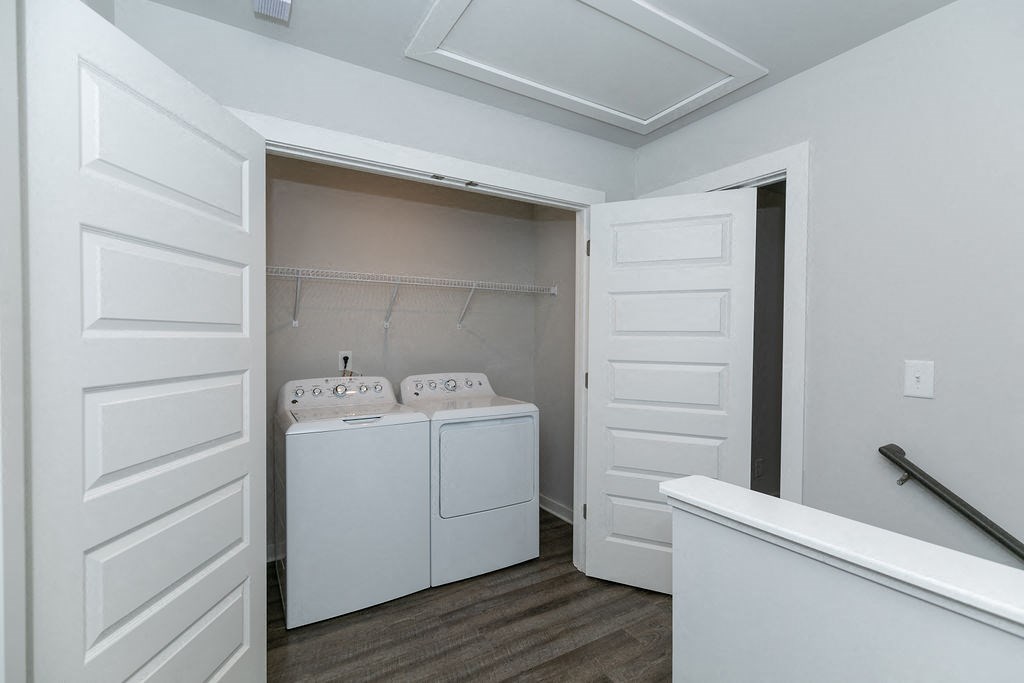 a laundry room with a washer and dryer and white doors
