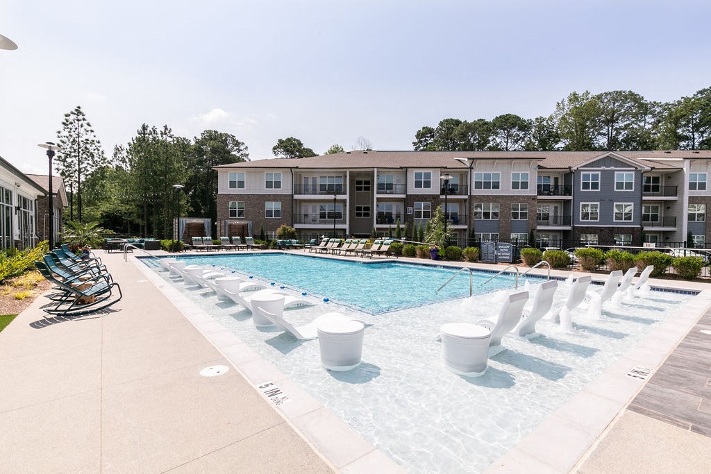 our apartments have a large pool with chairs and umbrellas