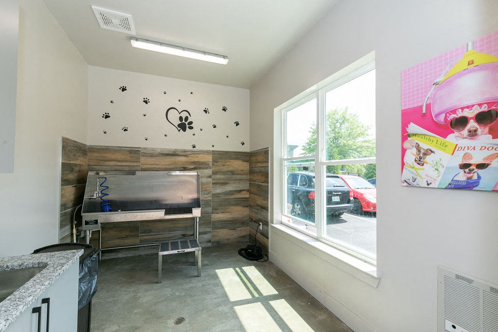 a living room with a piano and a window
