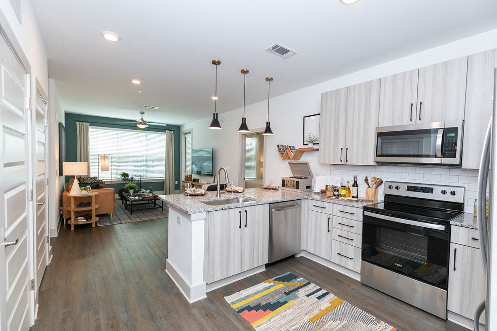 a kitchen with white cabinets and stainless steel appliances
