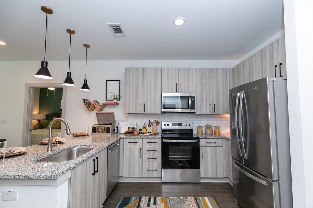 a kitchen with stainless steel appliances and granite counter tops