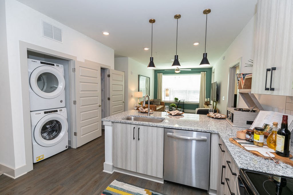 a kitchen with a washing machine and a sink