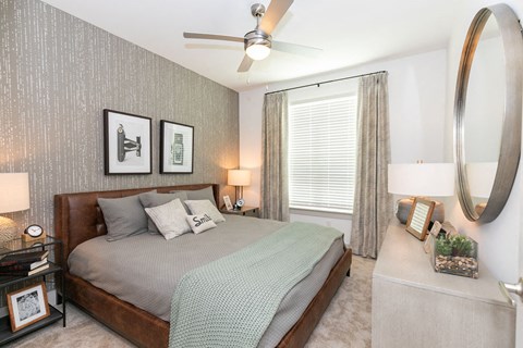 a bedroom with a bed and a ceiling fan