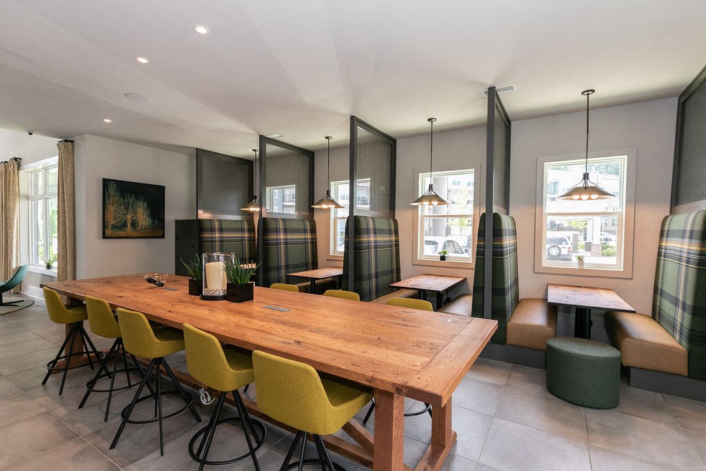 a dining room with a wooden table and yellow chairs
