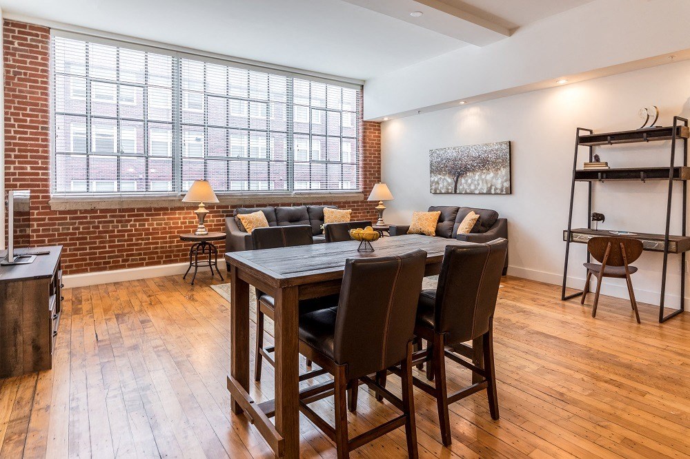 a dining room with a table and chairs in front of a large window
