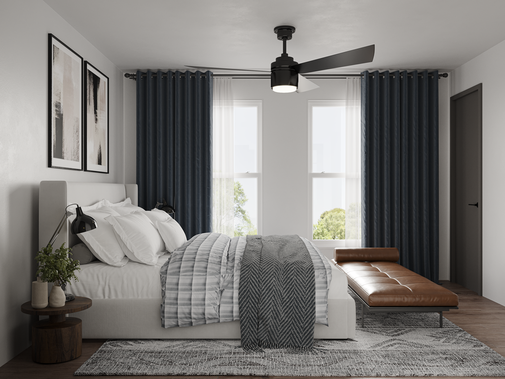 a bedroom with a bed and a ceiling fan