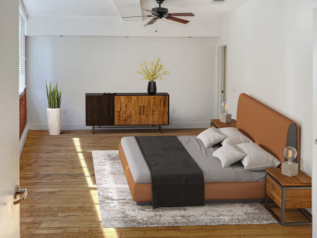 a bedroom with a bed and a ceiling fan