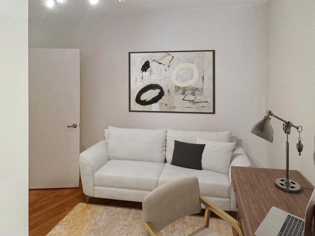 a living room with a white couch and a wooden table