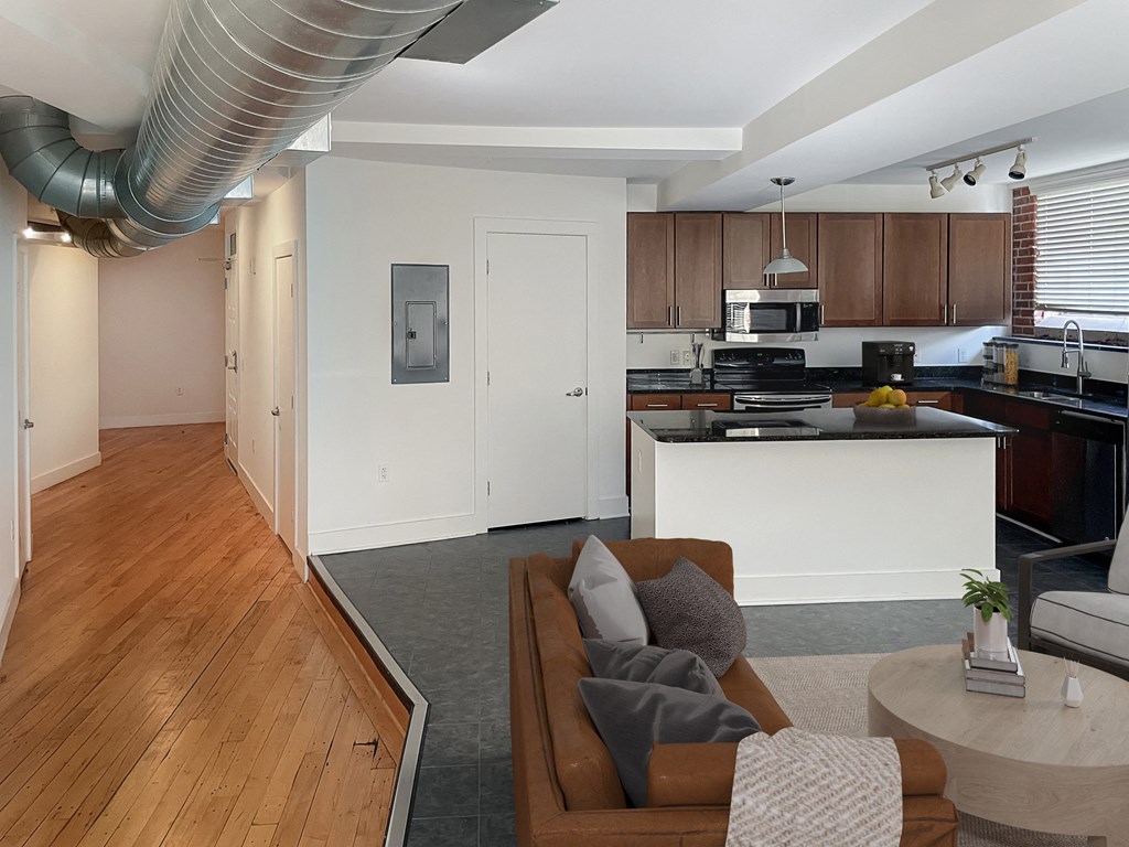 a kitchen and living room with a couch and a table