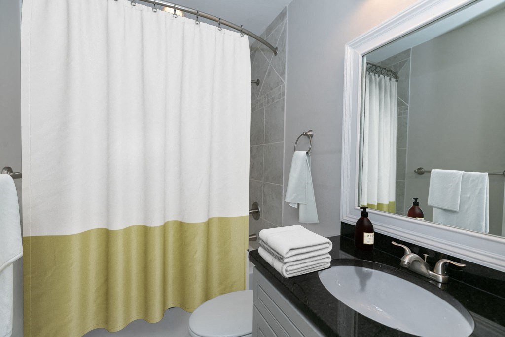 a bathroom with a shower curtain and a sink and a mirror