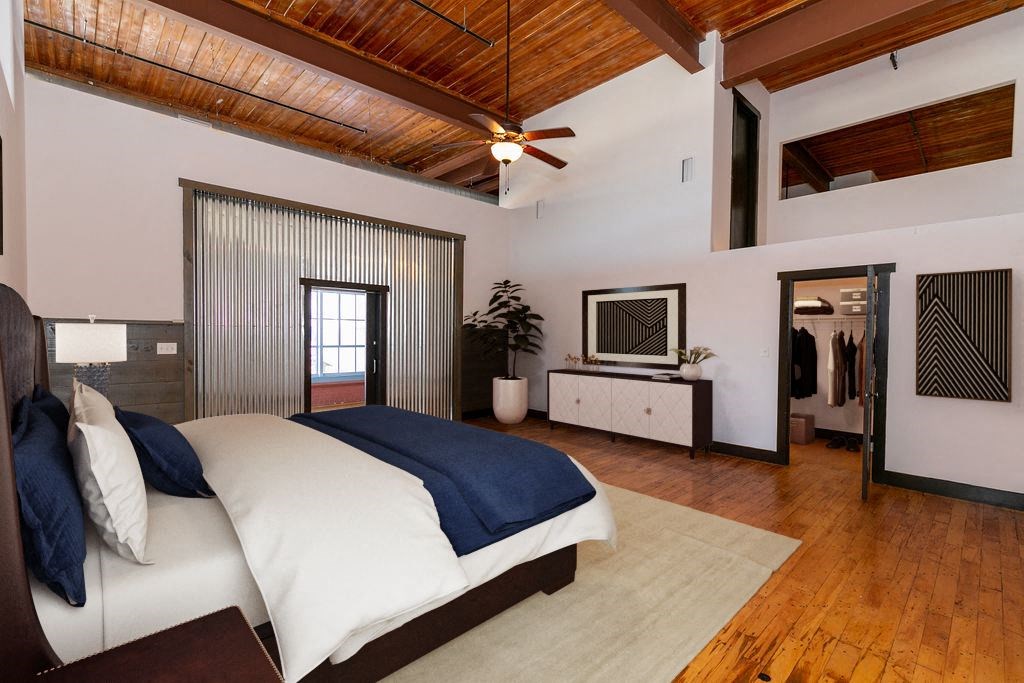 a bedroom with a bed and a dresser and a mirror