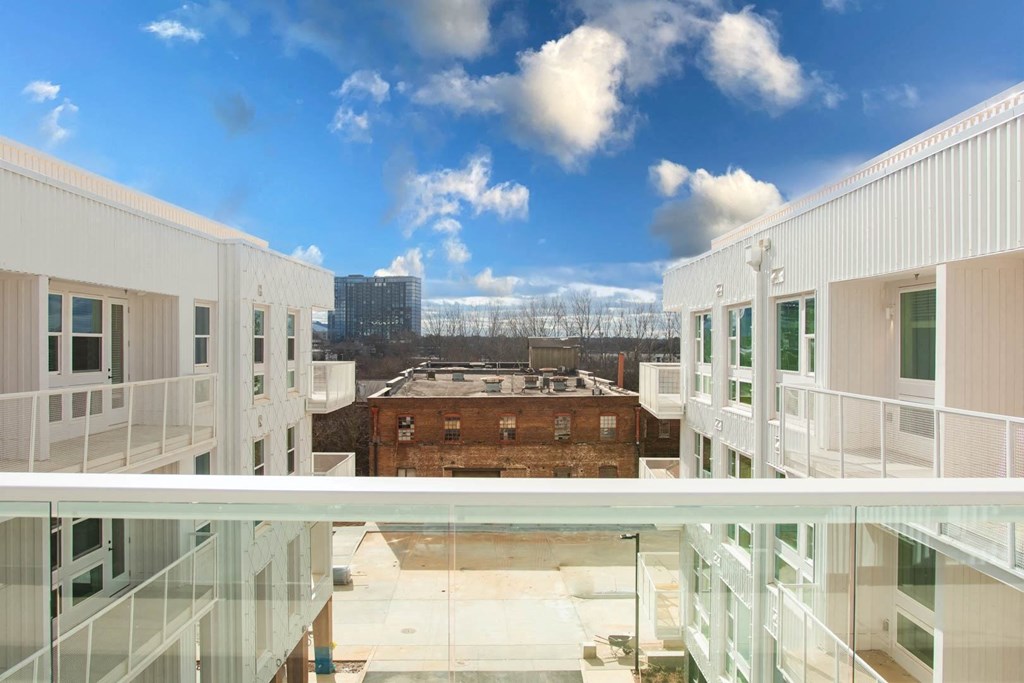 a view of a city from a balcony in a building
