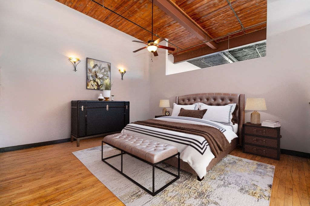 a bedroom with a bed and a ceiling fan