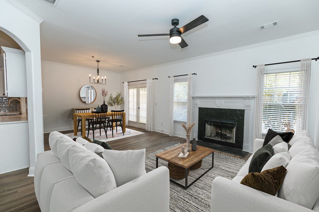 a living room with a white couch and a fireplace