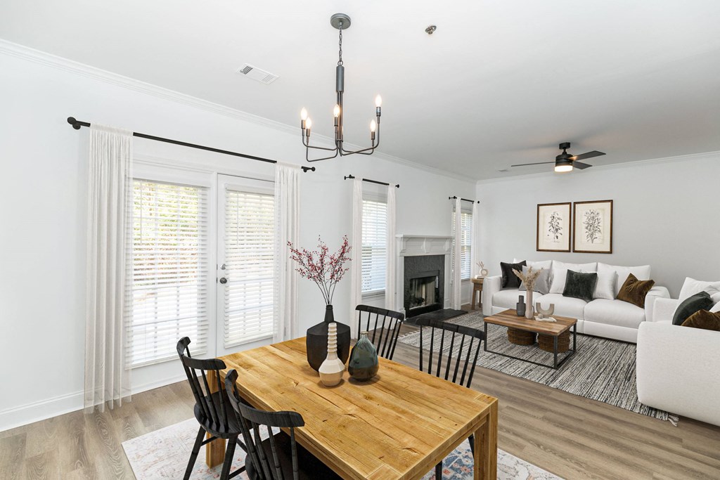 a living room with a dining room table and a fireplace