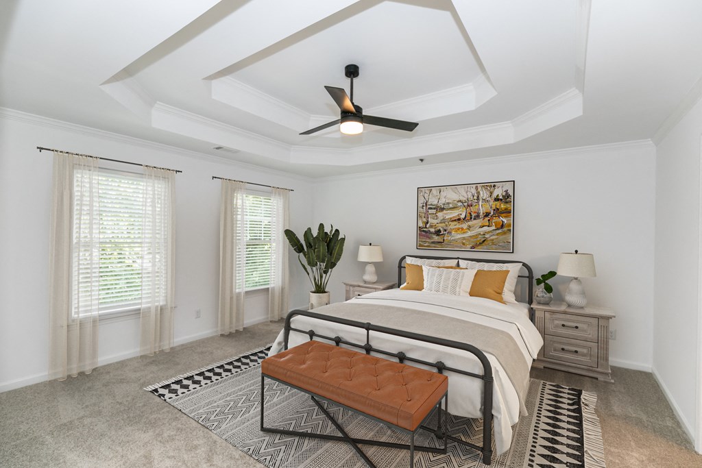 a bedroom with a bed and a ceiling fan