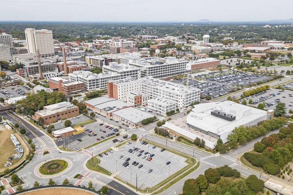 an aerial view of a city with buildings and cars