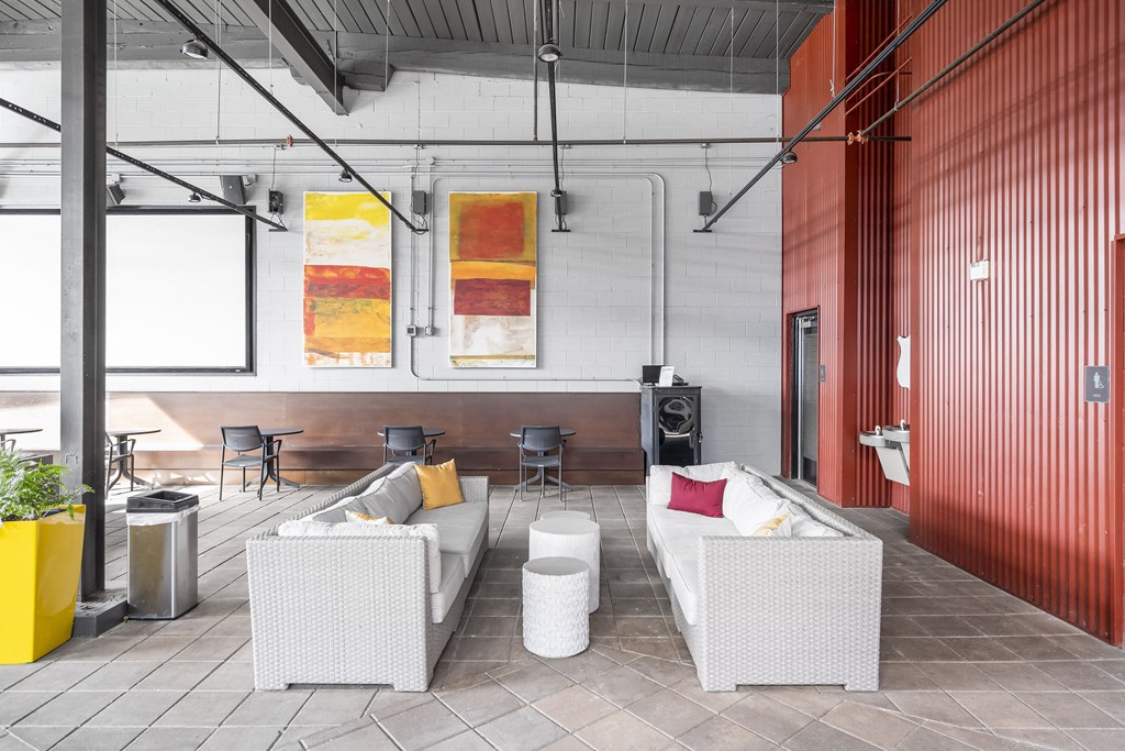 a living room with white furniture and red walls