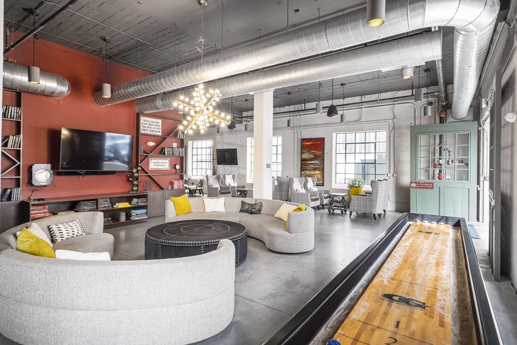 an open living room with couches and a bowling alley