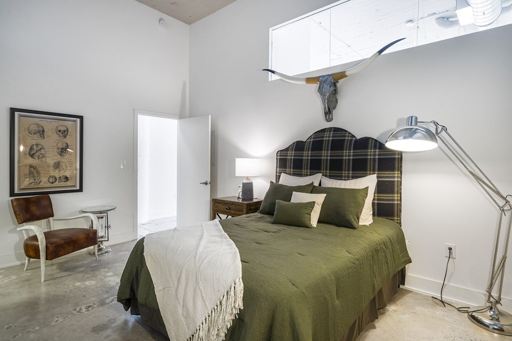 a bedroom with a bed and a skull on the wall