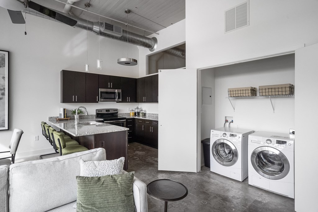 a kitchen and laundry room with a washing machine and a washer and dryer