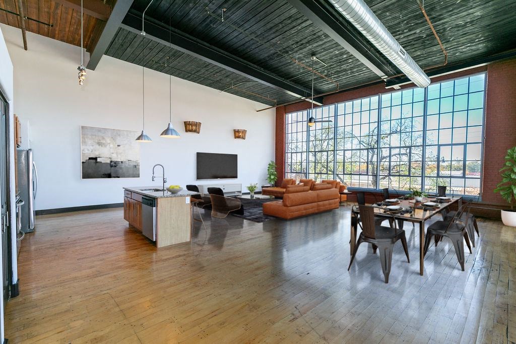 a large living room with a large window and a table and chairs