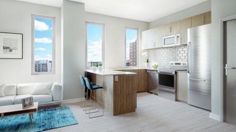 A kitchen with a refrigerator, sink, and a dining table with chairs.