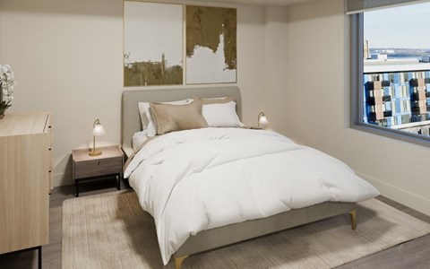 A bedroom with a large bed and a view of the city.