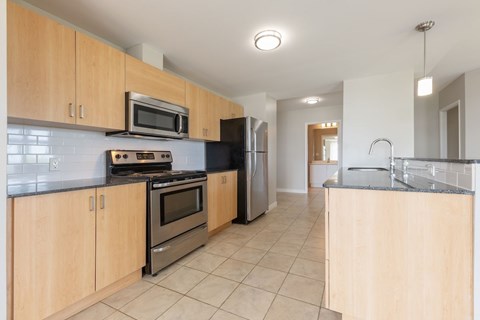 A kitchen with wooden cabinets and stainless steel appliances.