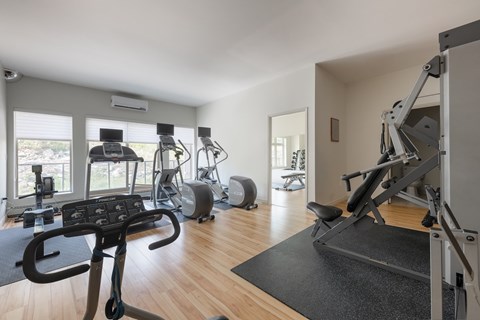 A spacious home gym with a variety of exercise equipment.