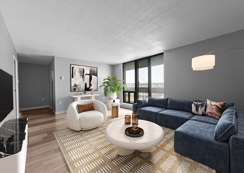 A living room with a blue couch and a coffee table.