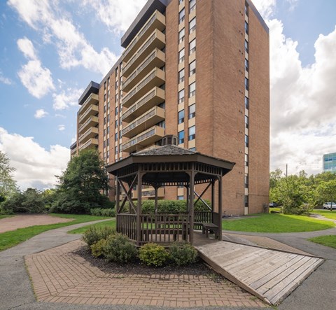 A tall building with a gazebo in front of it.
