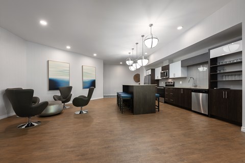 A modern kitchen with a dining area and two chairs.