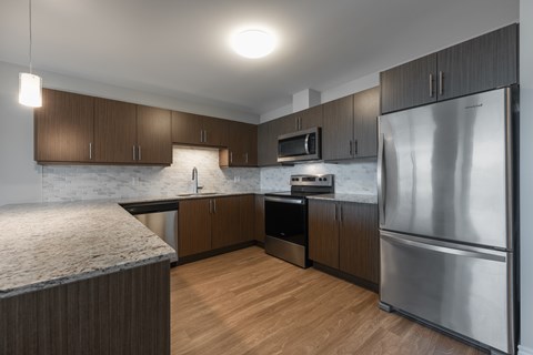 A modern kitchen with a refrigerator on the right.