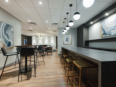 a dining room with tables and chairs and a bar