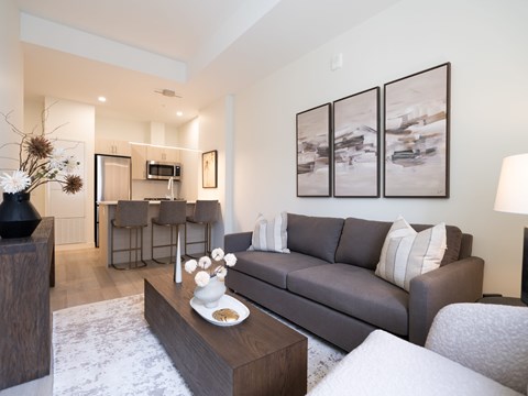 A modern living room with a grey sofa and a coffee table.