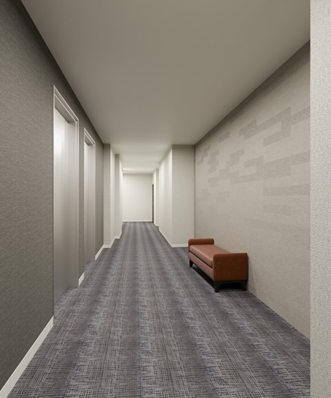 A long hallway with a bench on the right side.