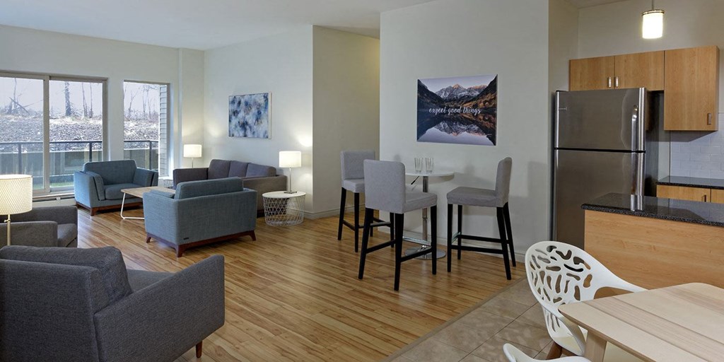 a living room and kitchen with a table and chairs