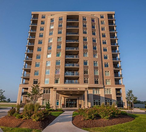 a tall building with a sidewalk in front of it