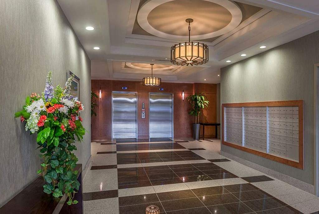 a lobby with a door and a plant