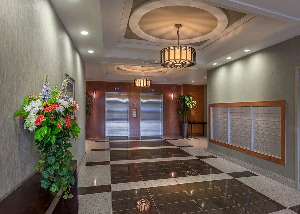 a lobby with a door and a plant