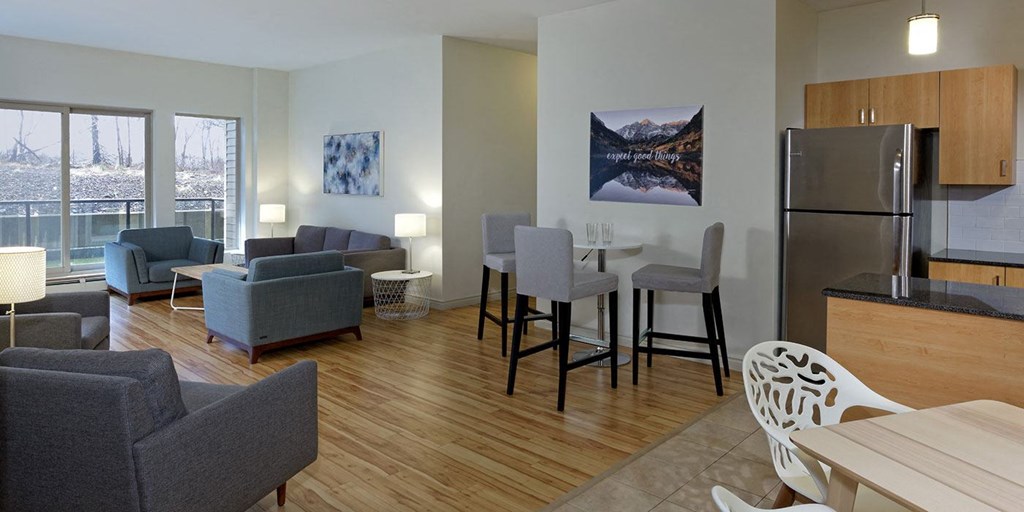 a living room and kitchen with a table and chairs