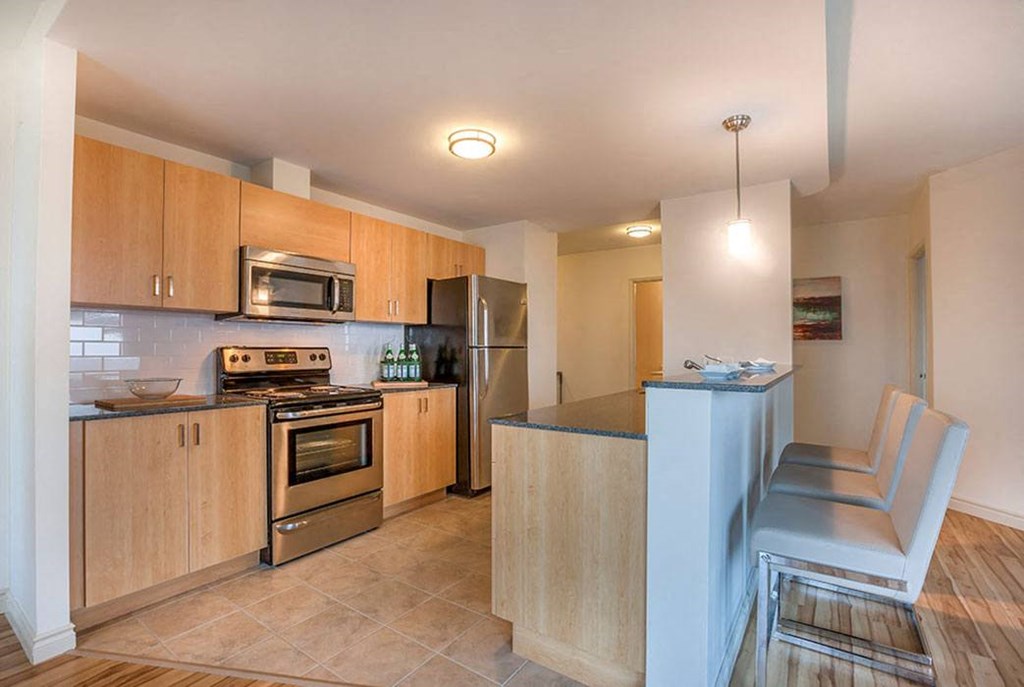 a kitchen with stainless steel appliances and wooden cabinets
