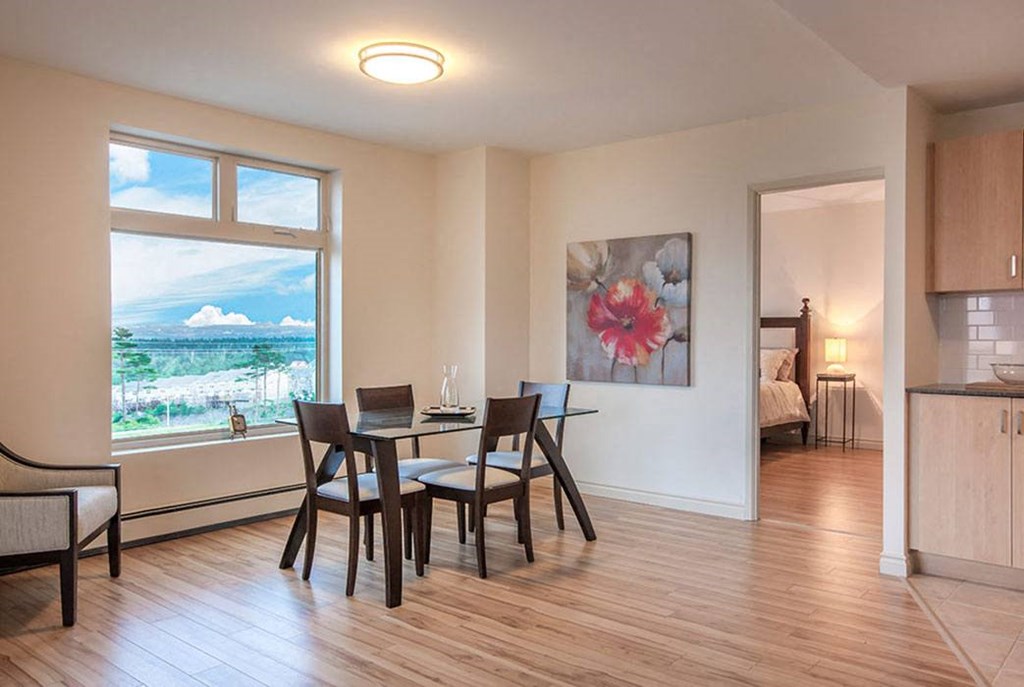 a dining room with a table and chairs and a window