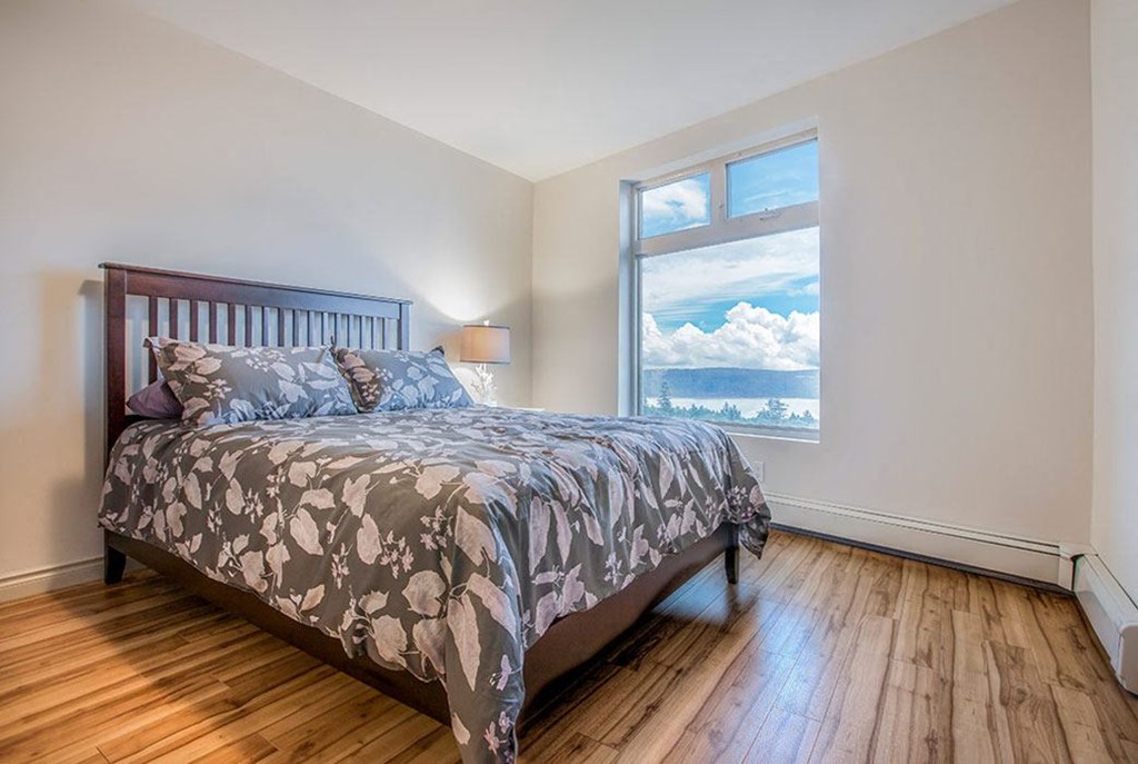 a bedroom with a bed and a window