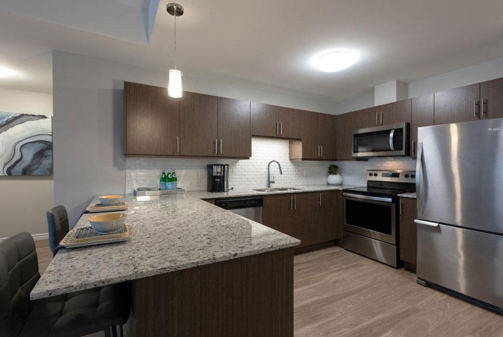 a kitchen with stainless steel appliances and a granite counter top