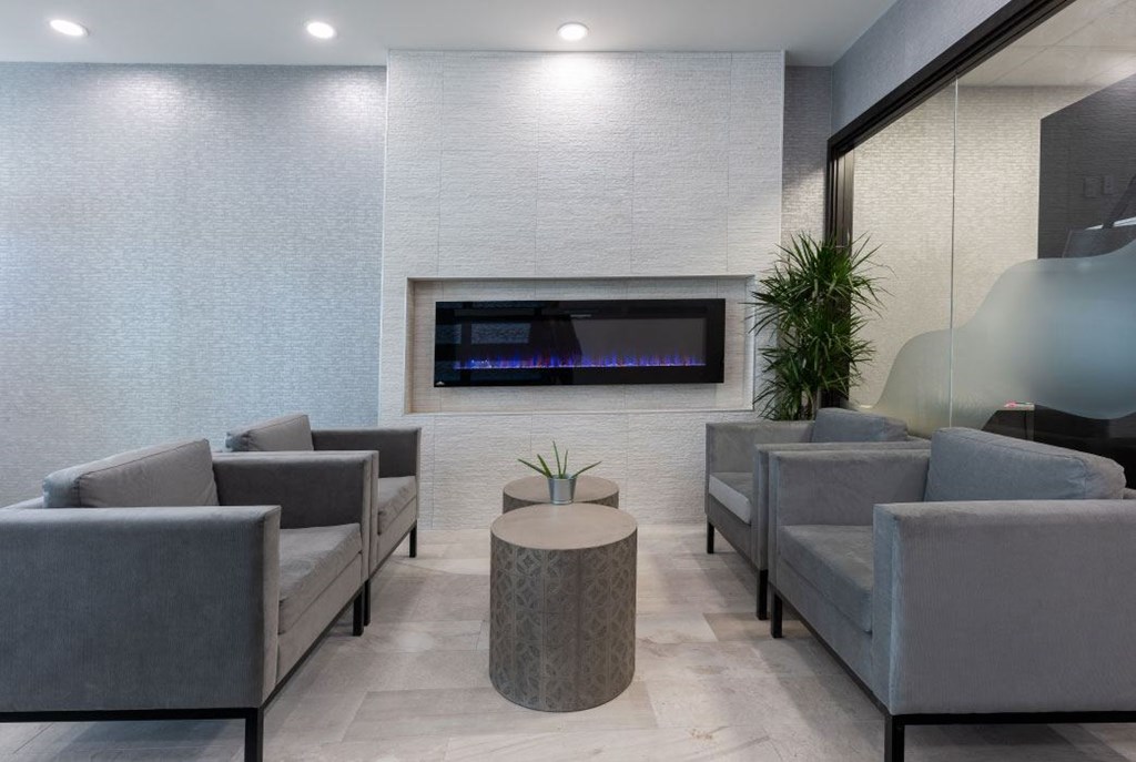 a lobby with couches and chairs and a fireplace