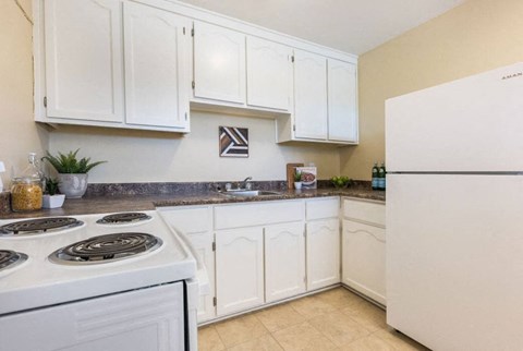 a kitchen with white appliances and white cabinets